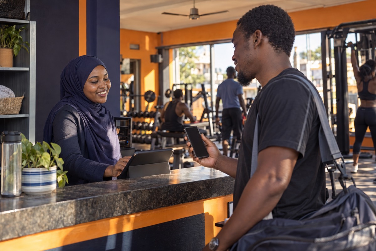 Receptionist checking in a member at a gym front desk